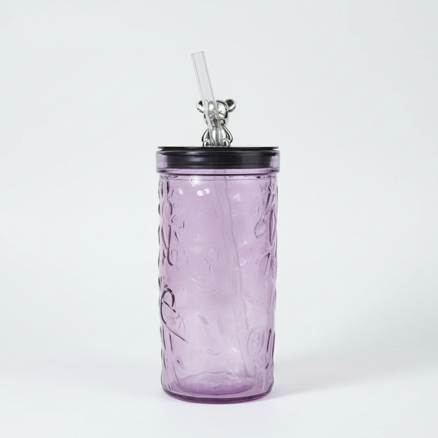 Purple textured tumbler with a black lid and straw on a white background