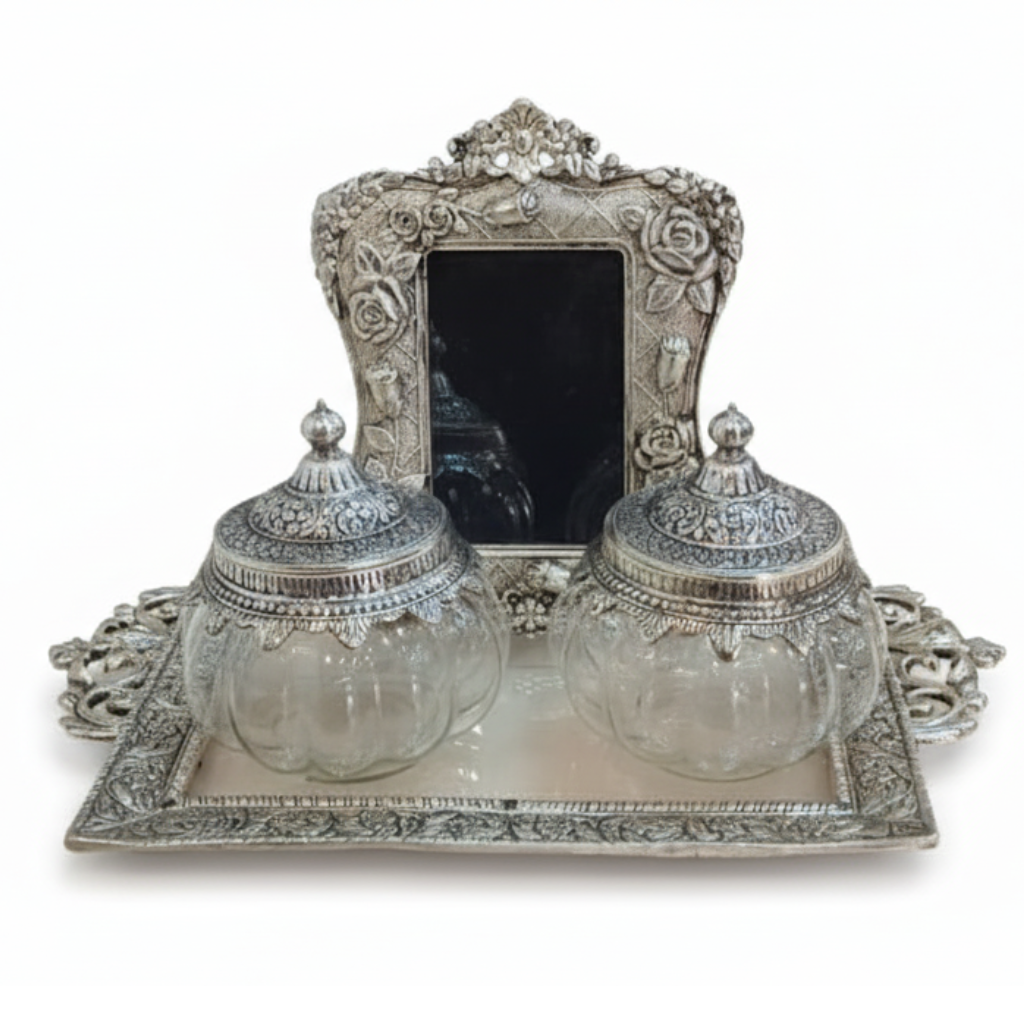 Decorative silver frame with two glass jars on a white background