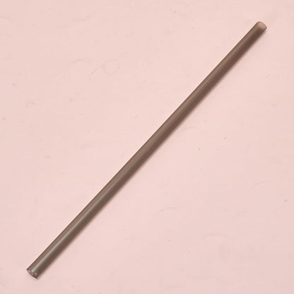 Long, thin metallic rod on a pink background