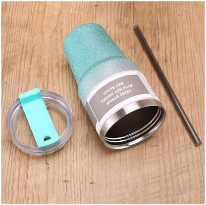 Turquoise insulated tumbler with straw and lid on a wooden surface