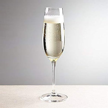 Champagne flute with bubbly champagne on a neutral background