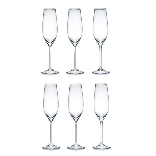 Set of six clear champagne flutes on a white background
