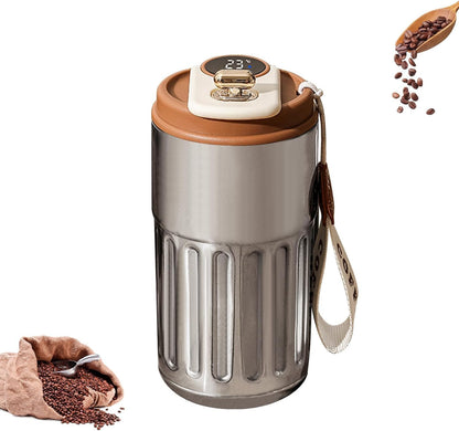 Silver and brown coffee grinder with coffee beans and a spoon on a white background