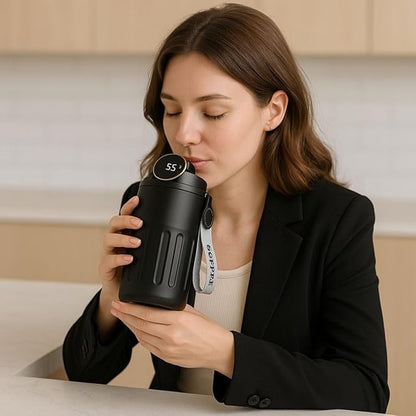 Woman holding a black water bottle with a digital display in a kitchen setting