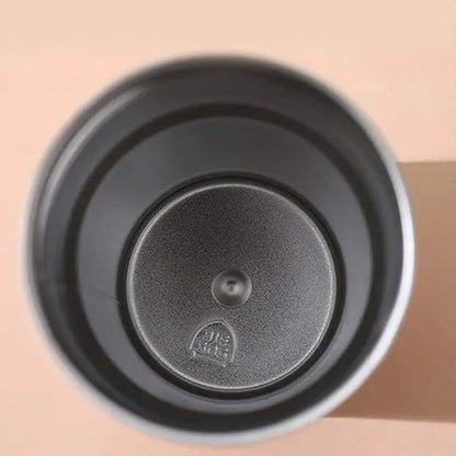 Black coffee filter with a brand logo on a beige background