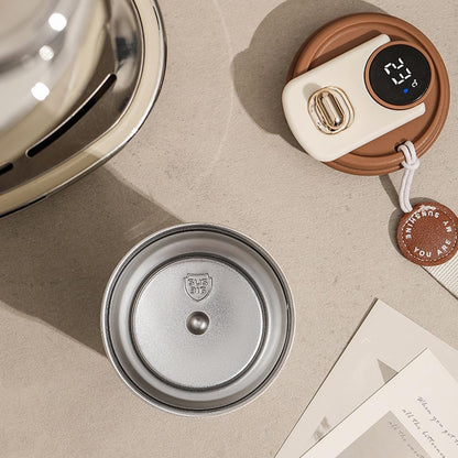 Metallic lid and white electronic device with brown cover on beige surface