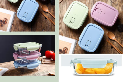 Set of colorful food storage containers on a wooden surface with spoons and a tomato.