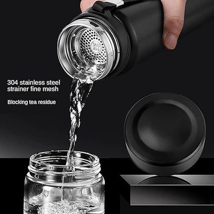 Black tea infuser with stainless steel strainer being used to pour water into a glass jar.