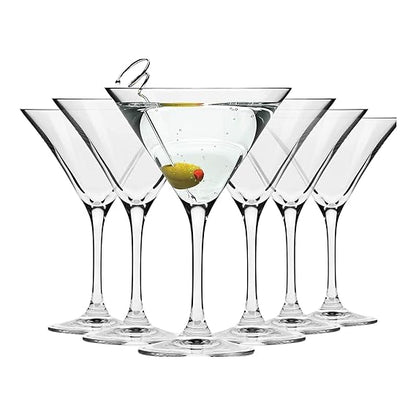 Set of six martini glasses with a lemon twist on a white background