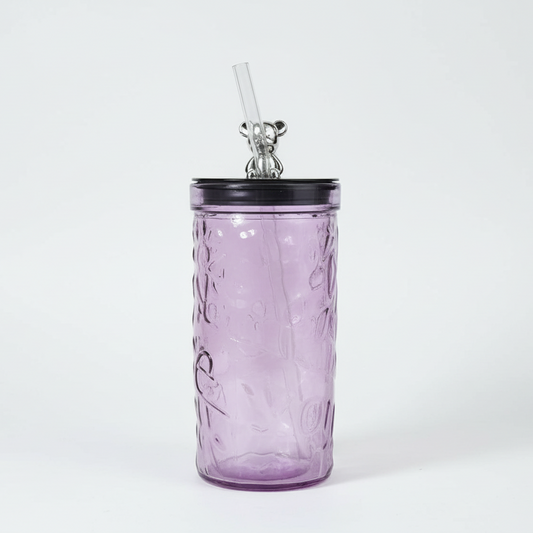 Purple textured tumbler with a black lid and straw on a white background